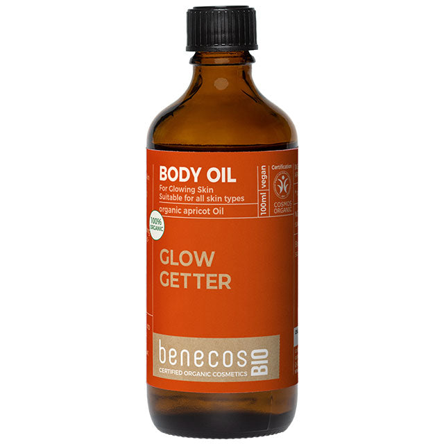 Benecos Bio Body Oil with Organic Apricot Oil for glowing skin is in a brown galss bottle with a screw top lid.