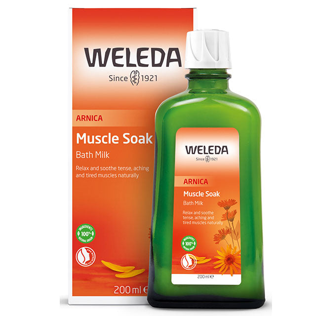 Weleda Arnica Muscle Soak Bath Milk in a green glass bottle in a orange box