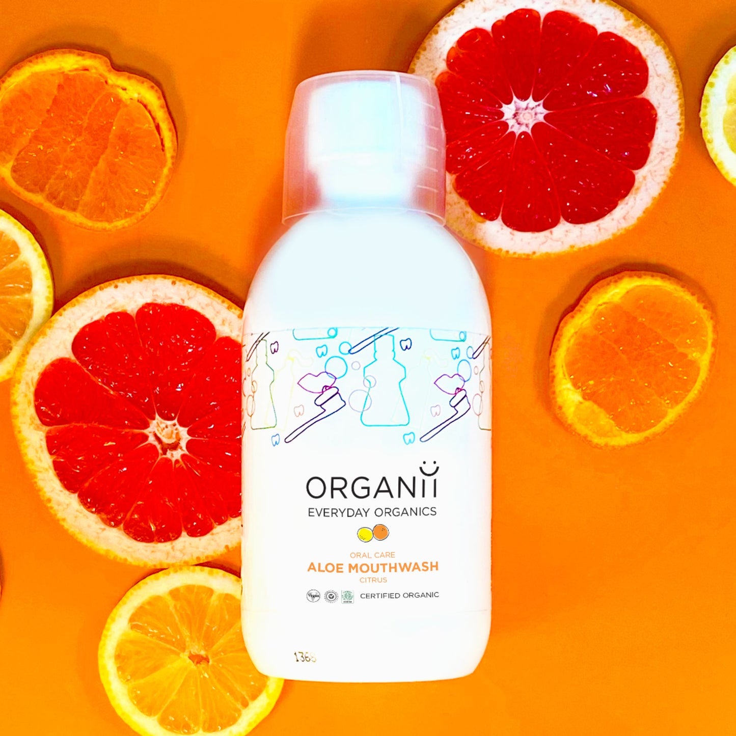 Organii Organic Mouthwash Aloe and Citrus in a plastic bottle with sliced oranges