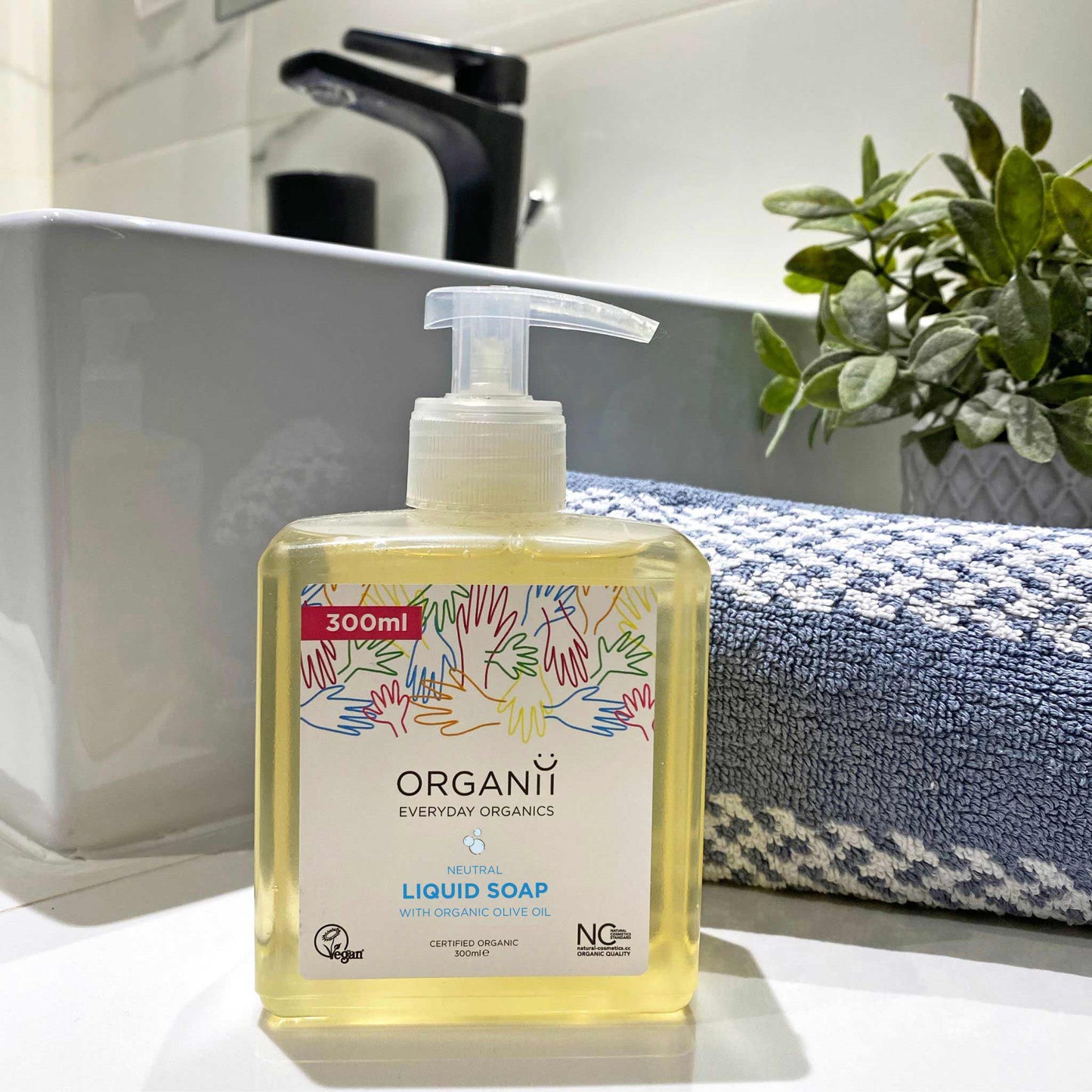 Organii Neutral Liquid Soap, Fragrance Free in a square plastic bottle with a pump in bathroom background