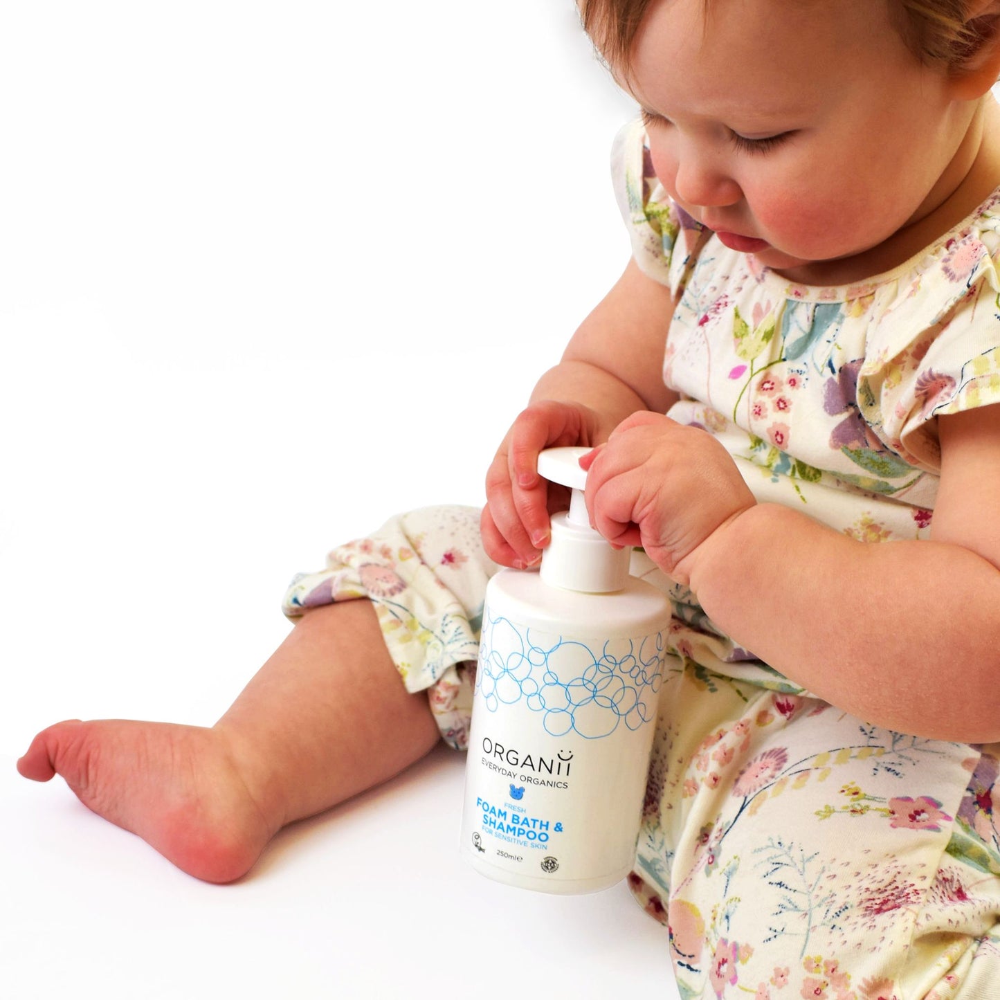 Organii fresh foam bath and shampoo for sensitive skin bottle with small child on white background