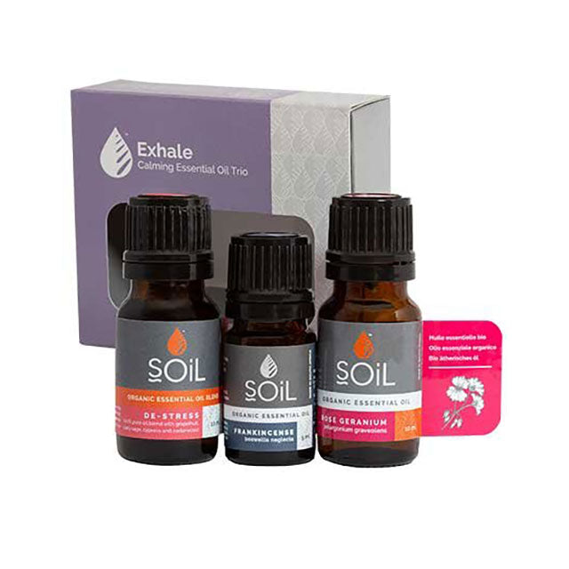 Soil Organic Essential Oil Gift Set contains Organic De-Stress Essential Oil Blend, Organic Frankincense Essential Oil and Organic Rose Geranium Essential Oil in a lilac and grey box.