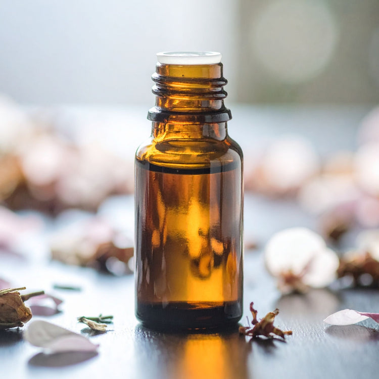 Natural and organic carrier oils, brown glass bottle with flower petals