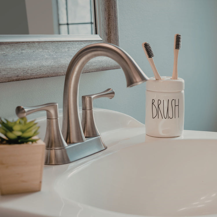 Natural and organic oral care natural toothbrush in bathroom sink