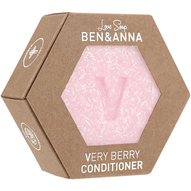 Ben and Anna Love Soap Very Berry Conditioner is in a hexagonal cardboard box with a hexagonal front cut out showing the pink speckled soap bar with a V 