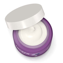 Lavera Firming Night Cream is in  a purple jar with a white lid propped open, showing a smooth white cream inside on a white background