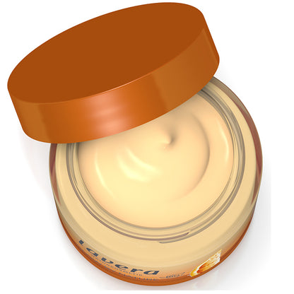 Lavera Glow by Nature Vitamin 3 in 1 cream in an open jar showing the cream coloured cream on a white background