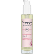 Lavera Indulgent Body Oil is in a glass bottle with a pink label and a white spray lid on  a white background