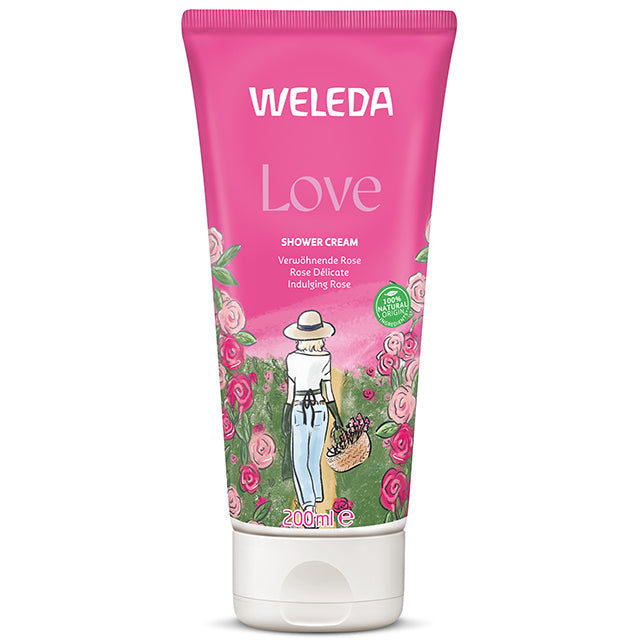 Weleda Love Shower Cream is in a pink tube with a floral design on the front on a white background.