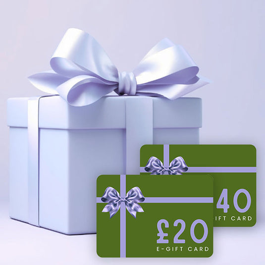 White gift box with a large white bow and two green e-gift cards with purple bows on a light gray background.