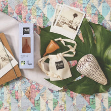 Period cup product packaging with 'FAIR Squared' branding on a map background