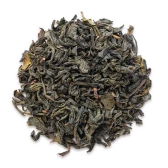 Dry green tea leaves on a white background