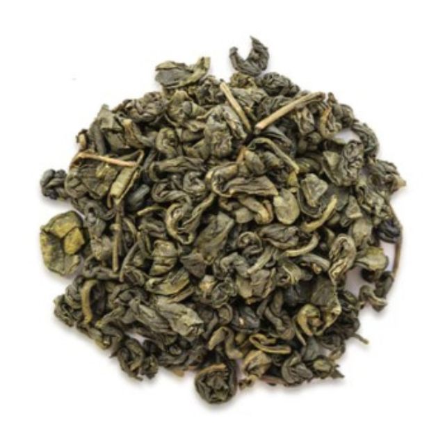 Pile of green tea leaves on a white background