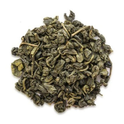 Pile of green tea leaves on a white background