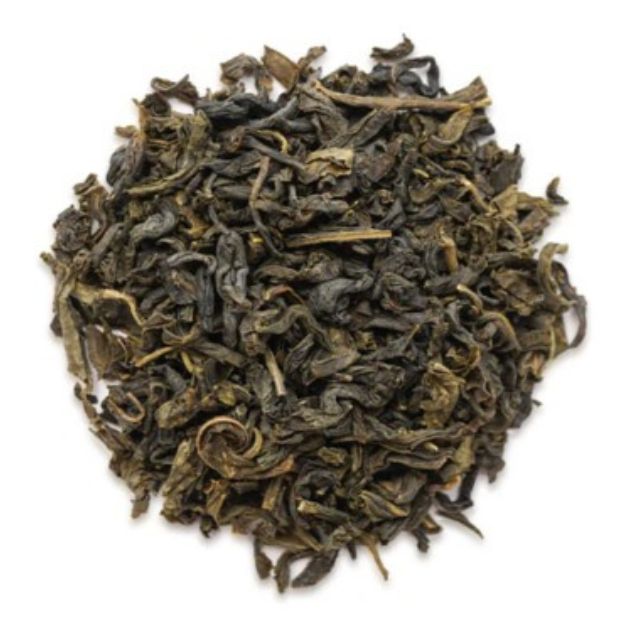 Dry green tea leaves on a white background