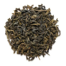 Dry green tea leaves on a white background