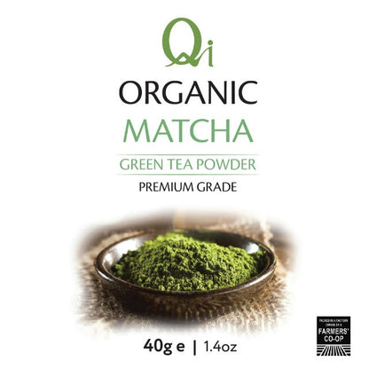 Qi Organic Matcha green tea powder packaging with a bowl of matcha on a white background