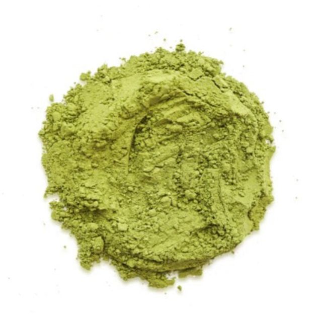 Green tea powder on a white background