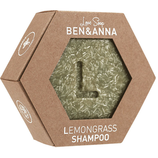 Ben and Anna Love Soap Lemongrass Shampoo is a bar soap in an hexagon shaped brown box with a haxagon shaped cut out revealing the soap bar which has an L in the middle of the bar shampoo