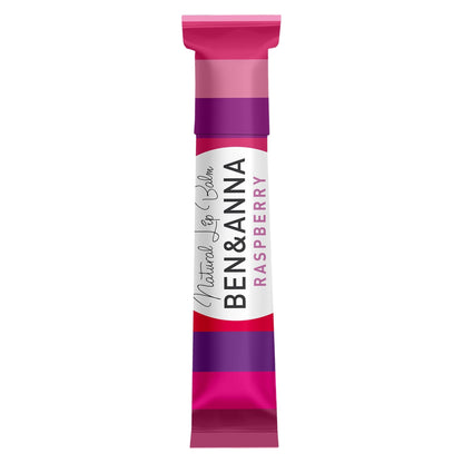 A single stick of Ben & Anna Natural Lip Balm Raspberry, shown vertically on a plain white background. The packaging features a white centered label with black and pink text, vibrant pink and purple bands.