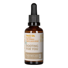 A 50ml amber glass dropper bottle of benecos BIO 'Rooting For You' organic carrot extract face oil, featuring a beige label with brown and yellow text, and a black dropper cap, set against a plain white background.