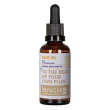 A bottle of Benecos Bio Face Oil made from organic plum seed oil, featuring an amber glass bottle, a black dropper cap, and a white label with brown and yellow text.