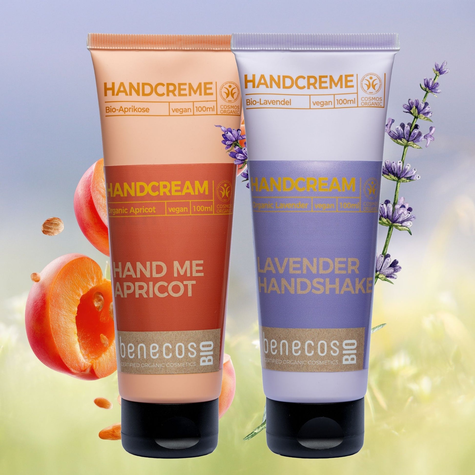 Two tubes of Benecos hand cream, one apricot and one lavender, on a colorful background with fruits and flowers.