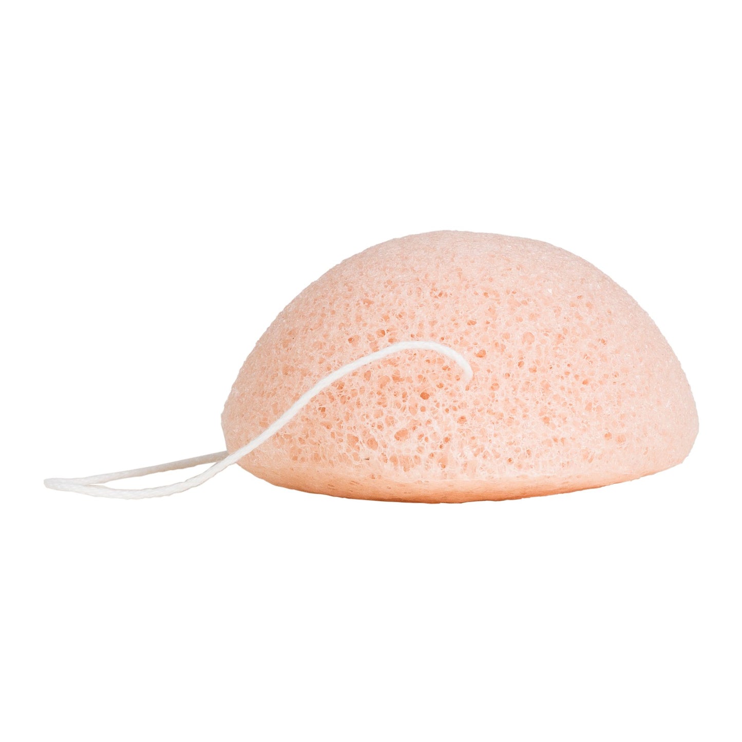 A peach-colored, dome-shaped porous sponge with a white elastic string attached, shown against a plain white background.