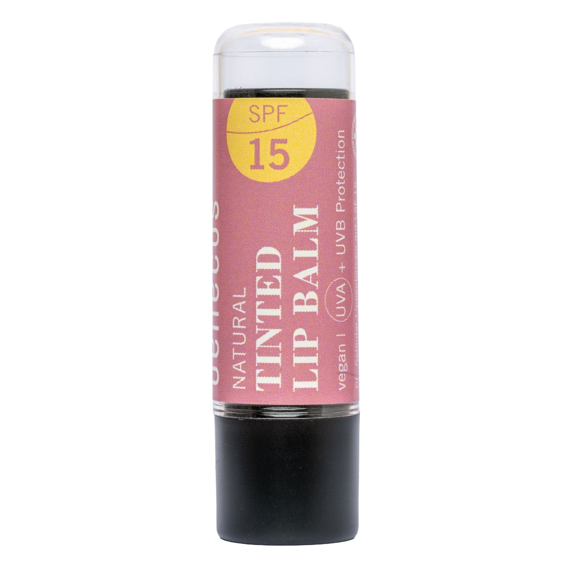 A single stick of benecos Natural Tinted Lip Balm with SPF 15, featuring a dusty pink label with a yellow sun graphic and a black base, isolated on a white background.
