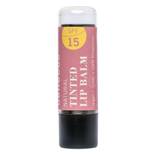 A single stick of benecos Natural Tinted Lip Balm with SPF 15, featuring a dusty pink label with a yellow sun graphic and a black base, isolated on a white background.