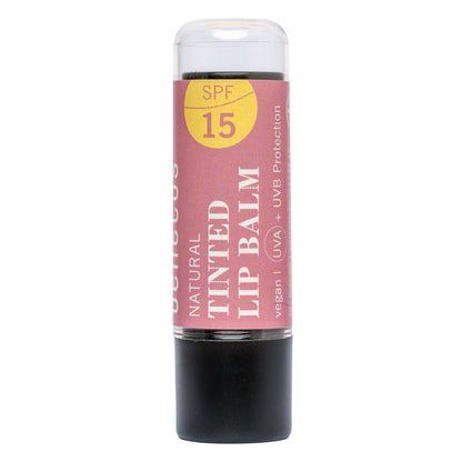 A single stick of benecos Natural Tinted Lip Balm with SPF 15, featuring a dusty pink label with a yellow sun graphic and a black base, isolated on a white background.