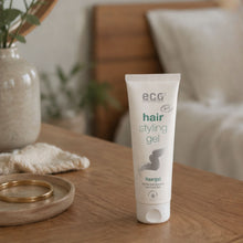 Tube of eco cosmetics hair styling gel in a bedroom background on a desk