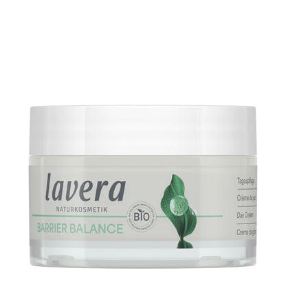 A jar of Lavera Barrier Balance Day Cream, featuring a white lid, a clear container showing the off-white cream inside, and a label with green leaf graphics and text.