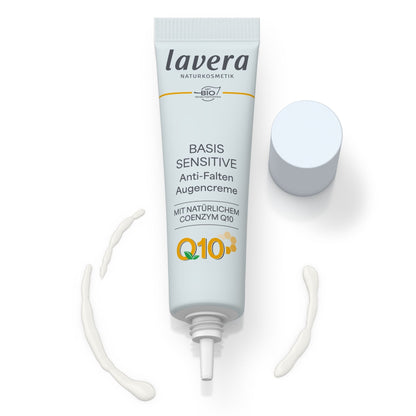 A white squeeze tube of lavera BASIS SENSITIVE Anti-Ageing Eye Cream with a white cap, open with eye cream shown on a solid white background.