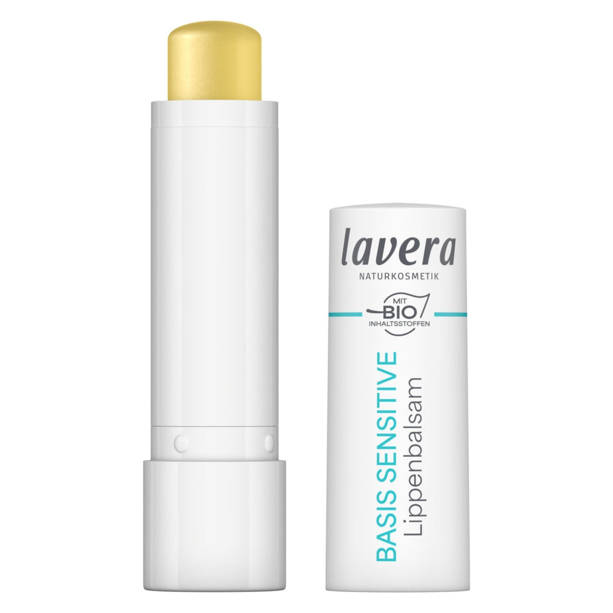 Lavera Basis Sensitive Lip balm shown with the white tube open, revealing a pale yellow balm stick, next to the white closed packaging tube with blue and black text on a white background.