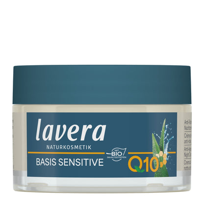 A jar of lavera Basis Sensitive Q10 cream, featuring a dark teal lid and a matching dark teal label with white and orange text, set against a plain white background.
