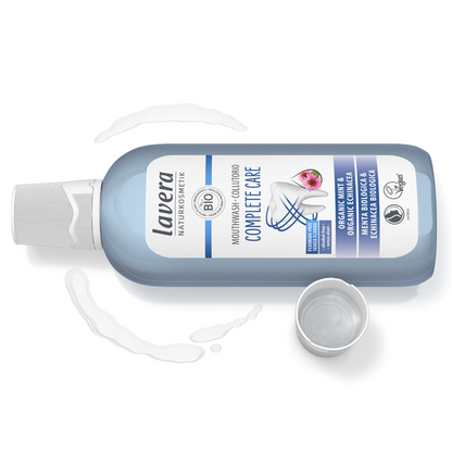 Lavera Mouthwash Complete Care laying down with the cap off. 