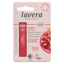 Lavera Repair Lip Balm in a pink blister card package, featuring a red tube of lip balm and a pomegranate graphic on a pale pink background.