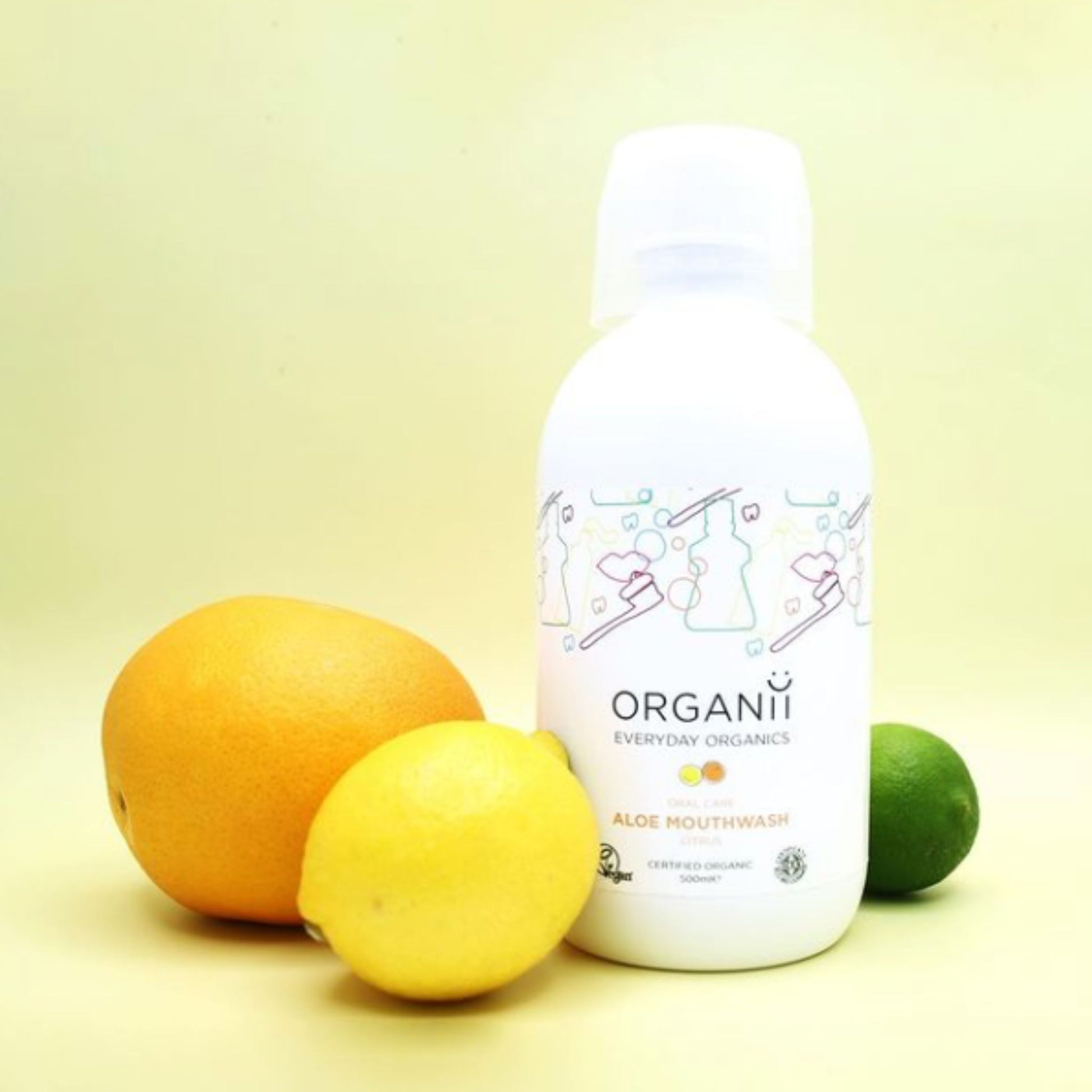 Organii Organic Mouthwash Aloe and Citrus in a plastic bottle with lemon, lime and orange