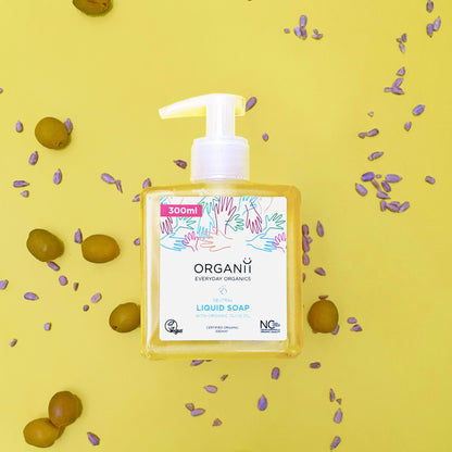 Organii Neutral Liquid Soap, Fragrance Free in a square plastic bottle with a pump on yellow background with olives