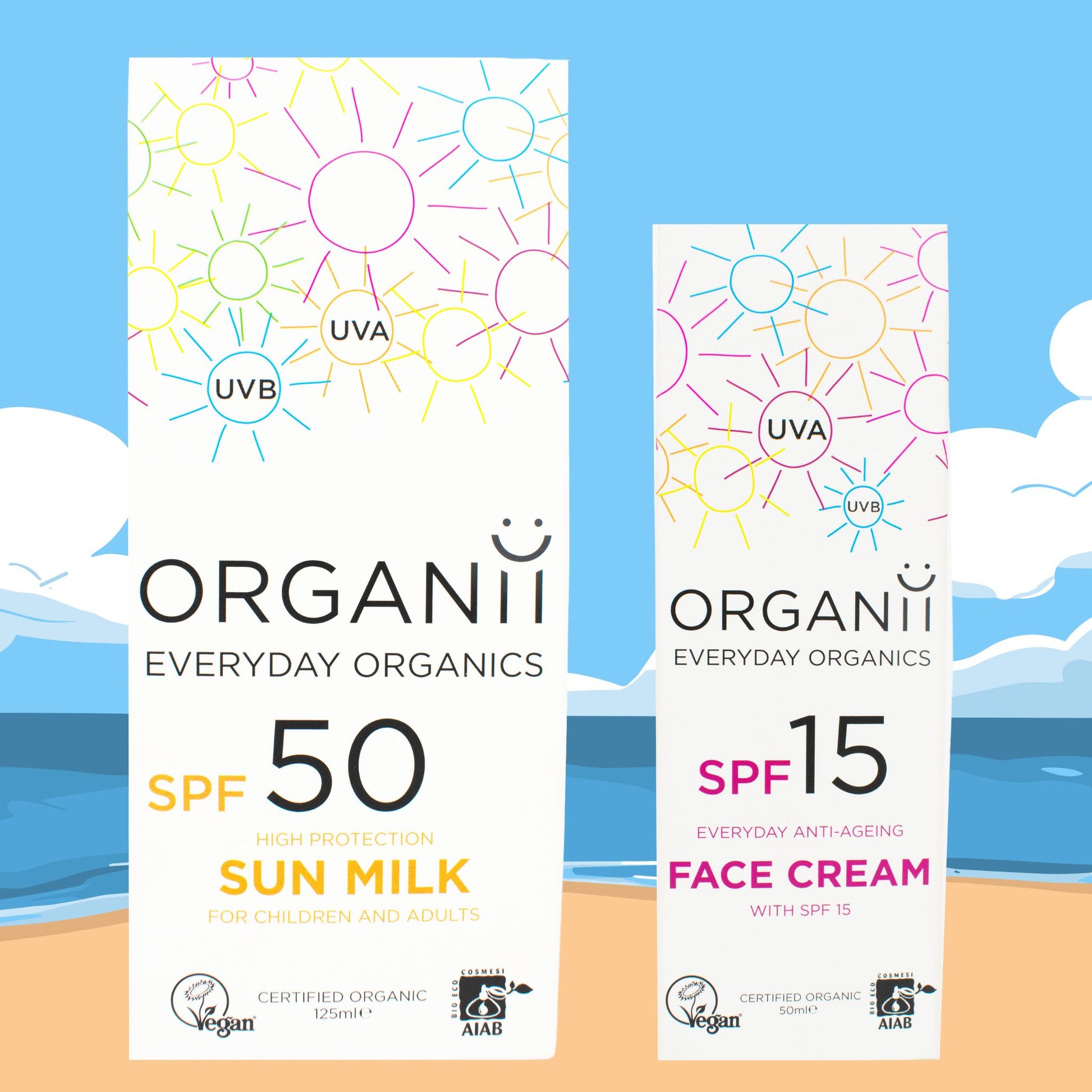 Box holding Organii SPF50 Sun Milk and a Box holding SPF15 Face Cream on a beach background