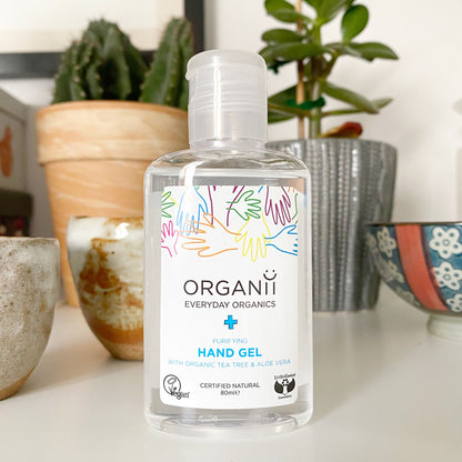 Organii Purifying Hand Gel with Organic in a clear plastic bottle on table