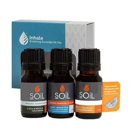 A trio of Organic Essential Oils, Cedarwood, Easy Breath and Sweet Orange in glass brown bottles wrapped in a blue and grey box. 