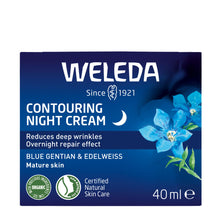 A 40 ml box of Weleda Contouring Night Cream, featuring a dark blue packaging with white text, blue flowers, and green leaves.