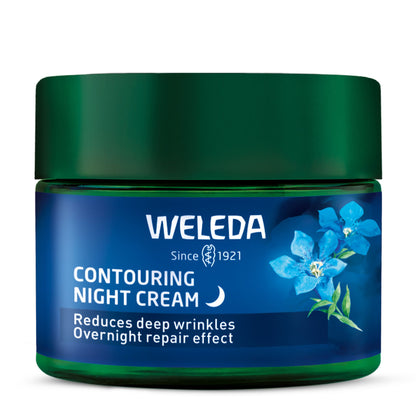 A jar of Weleda Contouring Night Cream with a dark green lid and a blue label featuring blue flowers, set against a plain white background.