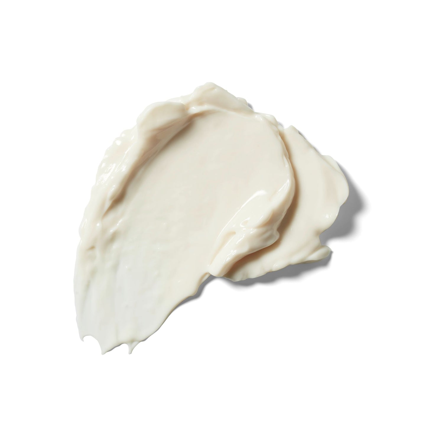 A dollop of creamy off-white weleda skin food nourishing day cream with a smooth, glossy texture, photographed on a solid white background.