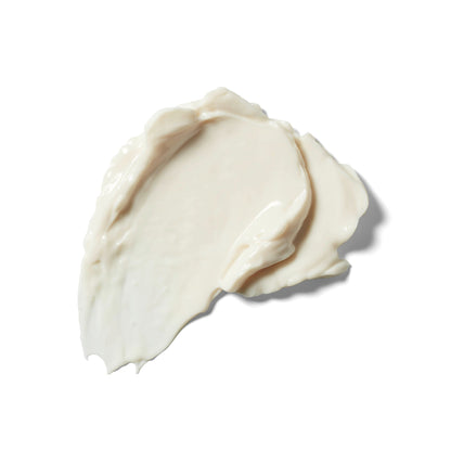 A dollop of creamy off-white weleda skin food nourishing day cream with a smooth, glossy texture, photographed on a solid white background.
