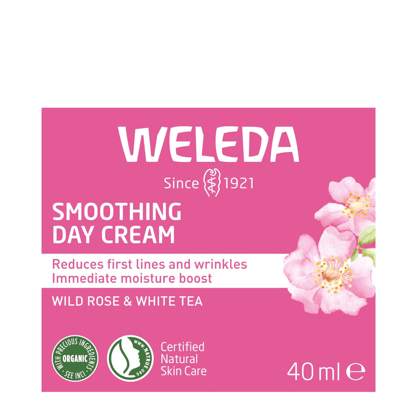 Weleda Smoothing Day Cream packaging box, featuring a pink background with white text, pink rose illustrations, and certification logos for organic and natural skin care. The box is centered on a plain white background.