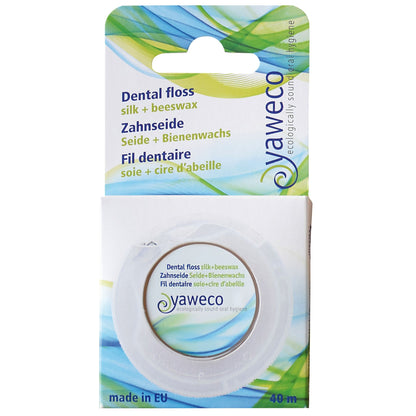 Yaweco dental floss packaging with green and blue design on a white background