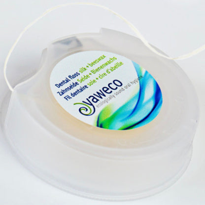 Yaweco dental floss container on a white background